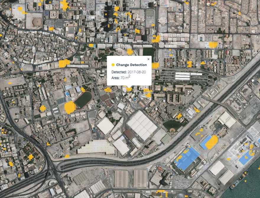 Yellow is persistent, detected change; white polygons are buildings mapped in OpenStreetMap; and blue polygons are OpenStreetMap buildings that have not been edited since a detected change.