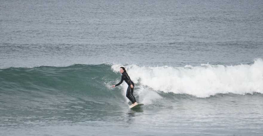 Lilly surfing on the Pacific Ocean