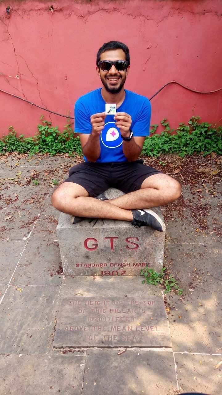 Sajjad rooting for OpenStreetMap at the geographic center benchmark of the Great Trigonometric Survey of India.
